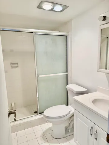 a bathroom with a shower a toilet and a sink