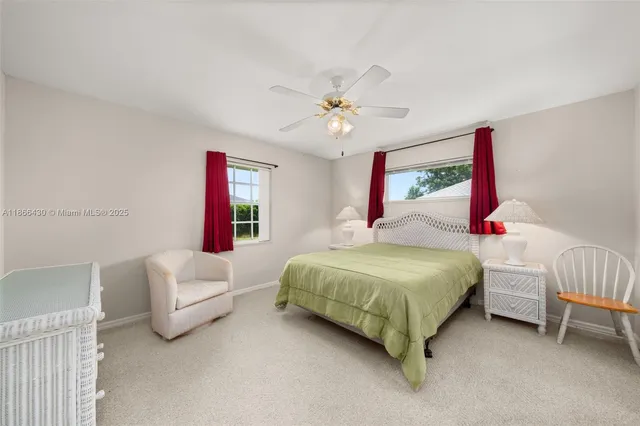 a bedroom with a bed painting on wall and a window