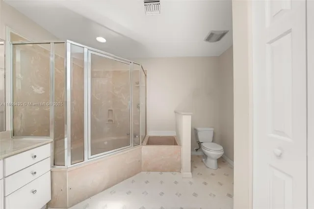 a bathroom with a shower a toilet and a shower