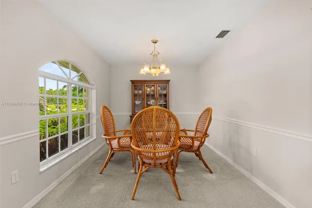 a view of a dining room with furniture window and outside view