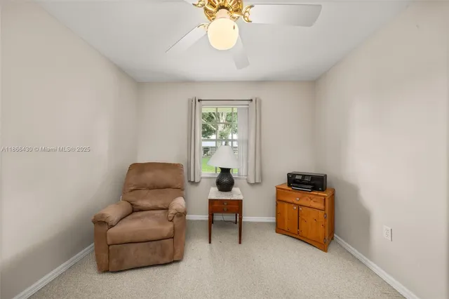 a living room with furniture a chandelier and a window