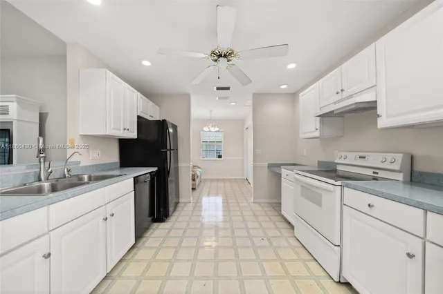 a kitchen with a sink stove and refrigerator