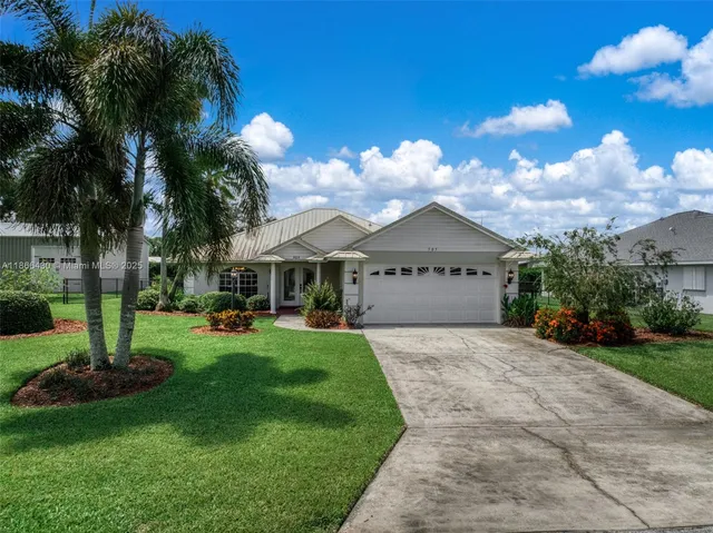 a view of a house with a yard and a garden