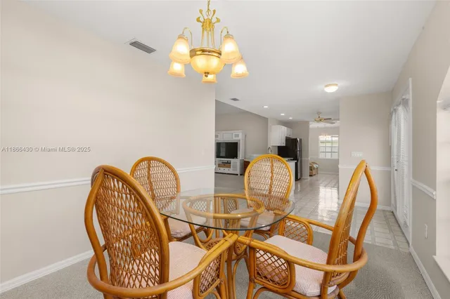 a view of a dining room with furniture and chandelier