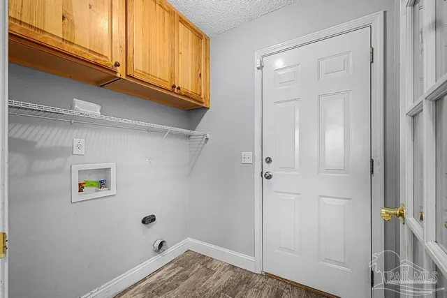 a view of storage and utility room with a wooden floor