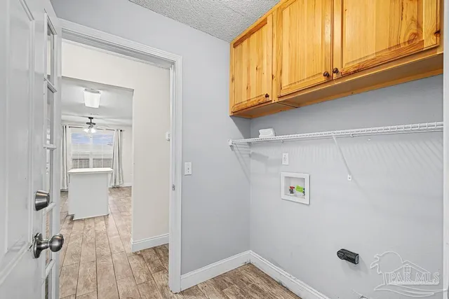 a view of a storage & utility room with a sink