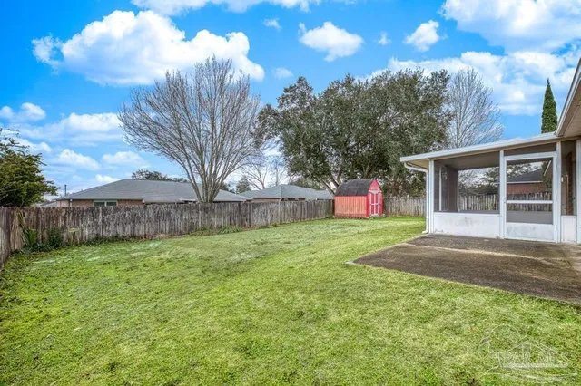 a backyard of a house with lots of green space and fountain