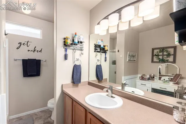 a bathroom with a sink double vanity granite and a mirror