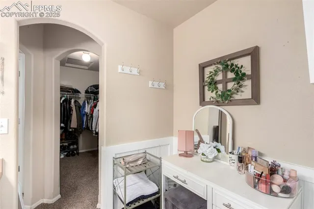 a view of a hallway to a livingroom and furniture
