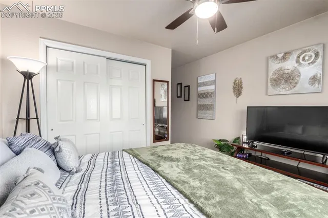 a bedroom with a bed and a flat screen tv