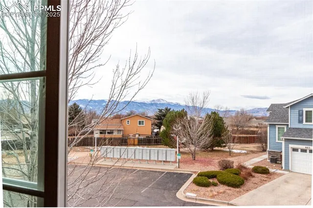 a view of a patio with couches and table and chairs and potted plants