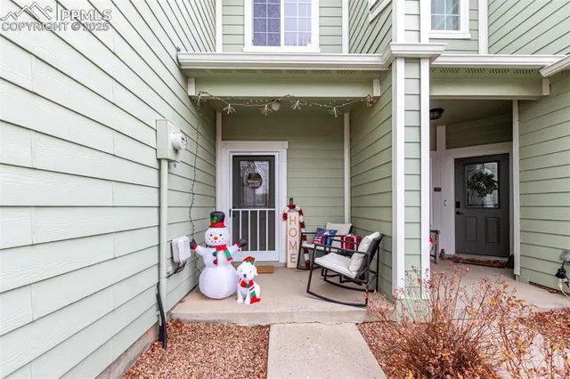 a front view of a house with sitting area