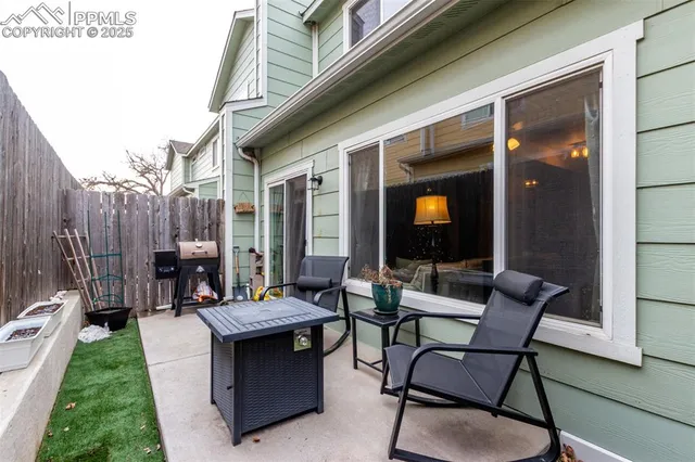 a backyard of a house with outdoor seating
