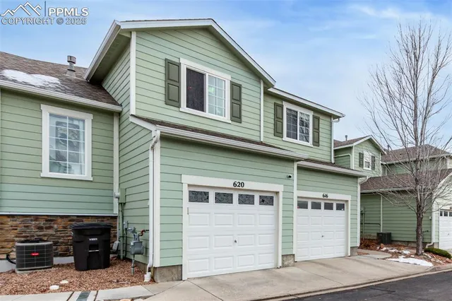 a front view of a house with garage