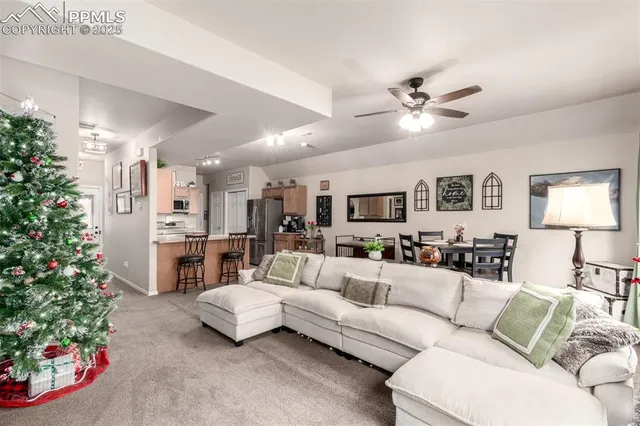 a living room with furniture a dining table a lamp and a potted plant