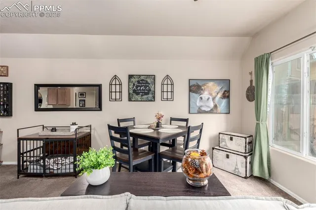 a dining room with wooden floor and white furniture