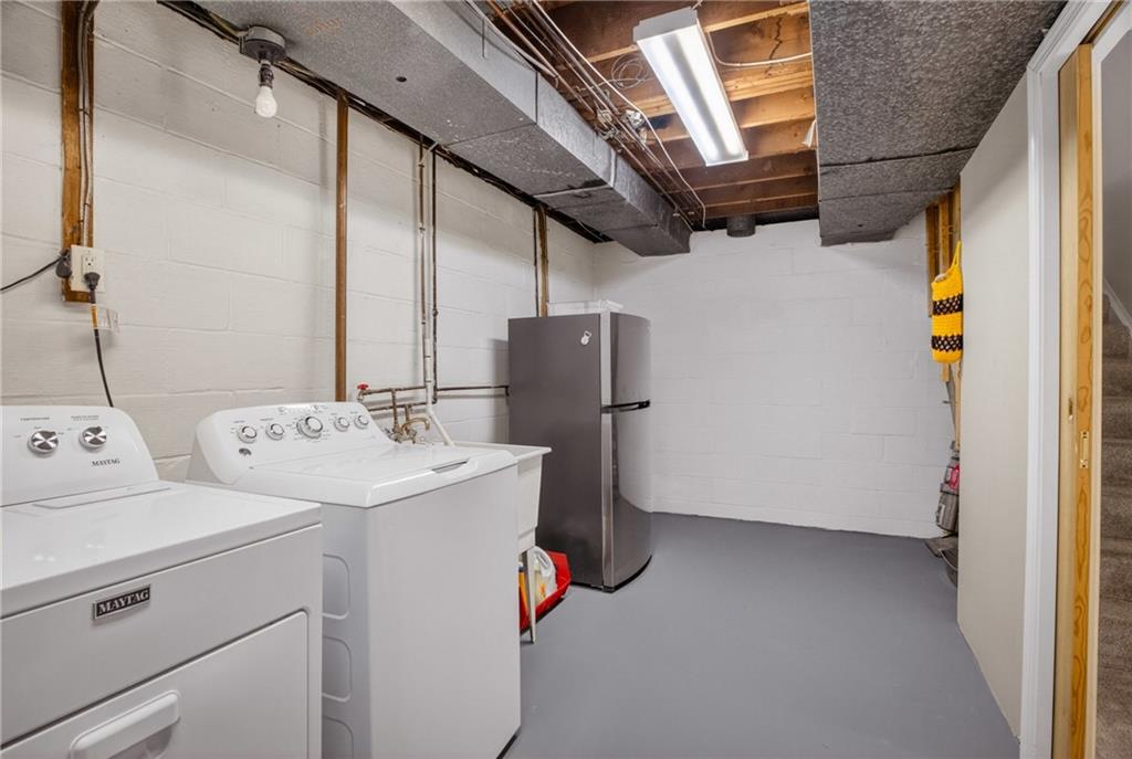1243 Sun Ridge Drive Pittsburgh, PA 15241 - Photo 34 of 43 This pristine utility space provides abundant room for chores and extra storage. Featuring well-maintained laundry appliances, a deep utility sink, and plenty of space for additional shelving or a workshop area.