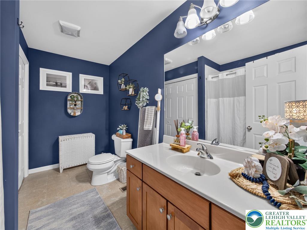 4148 Ross Road Bethlehem, PA 18020 - Photo 60 of 67 A deep blue wall color highlights a single vanity and shower, enhancing this well-appointed bathroom.