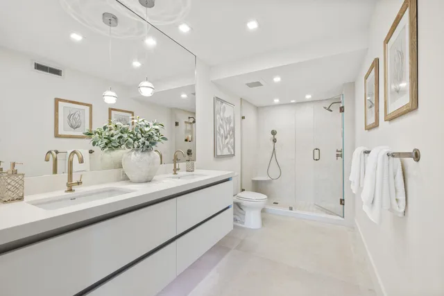 a bathroom with a toilet a sink and a mirror