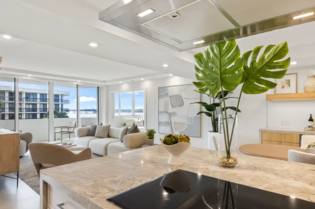 a kitchen with stainless steel appliances granite countertop a sink a stove and a wooden floors