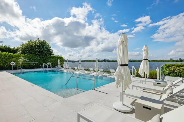 a view of a kitchen with kitchen island large appliances wooden floor and living room view