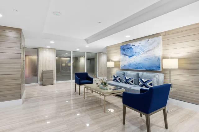 a front view of a house with a yard and potted plants