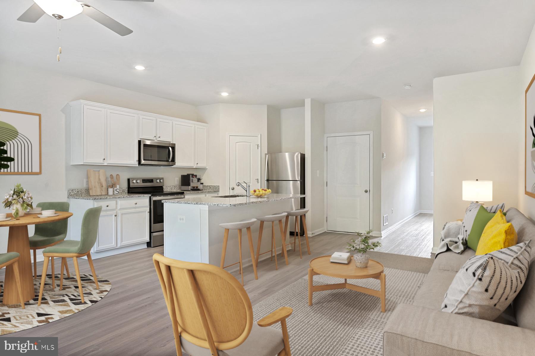 a living room with furniture and a kitchen