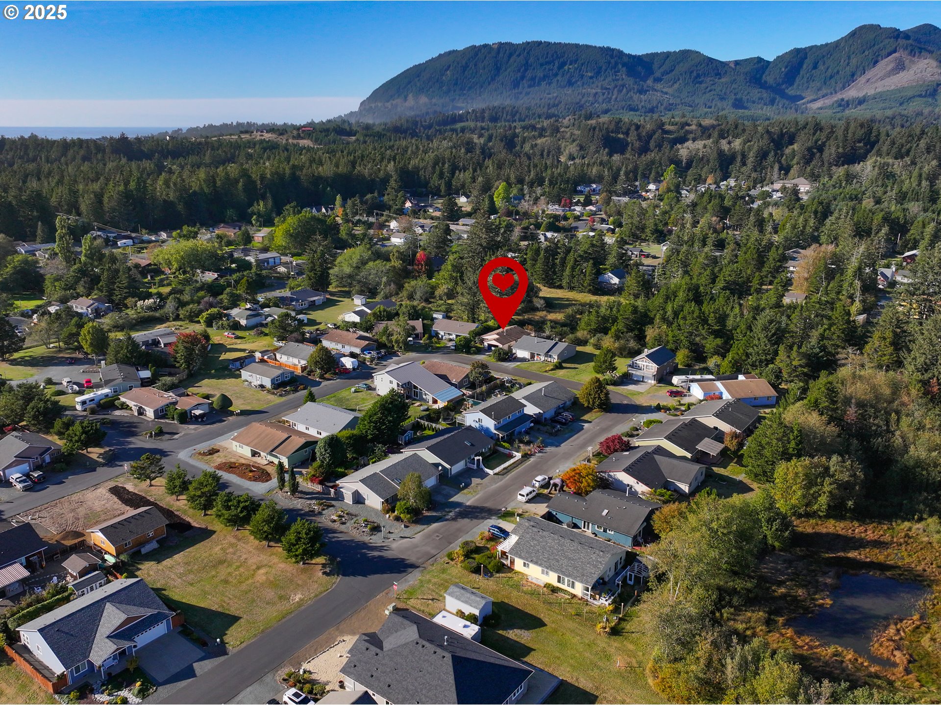 34130 Pintail Avenue Nehalem, OR 97131 - Photo 2 of 25 an aerial view of residential houses and outdoor space
