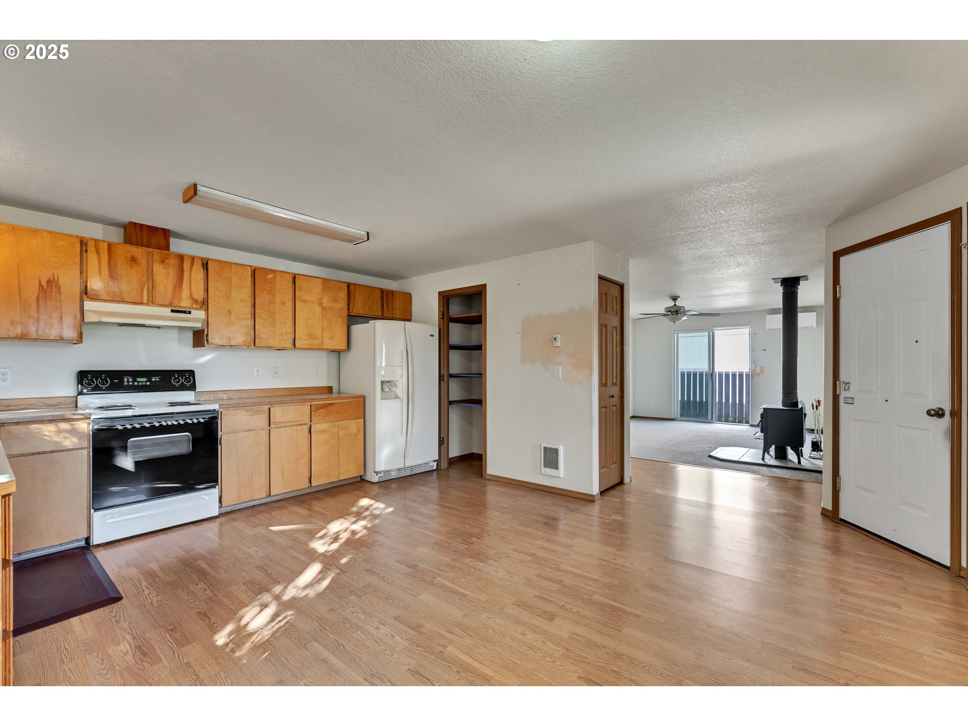 34130 Pintail Avenue Nehalem, OR 97131 - Photo 7 of 25 a kitchen with a refrigerator and a stove top oven