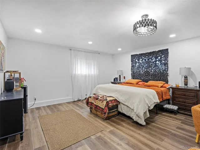 a large bedroom with a bed and a flat screen tv