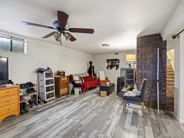 a bedroom with a bed a large window and book shelf