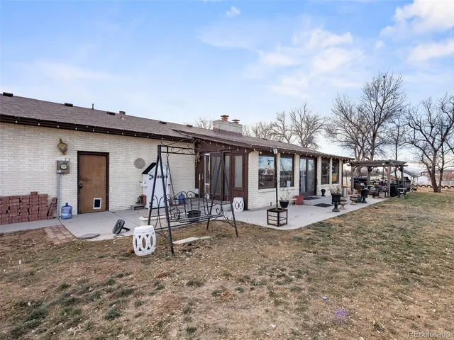 a view of a house with swimming pool and a yard