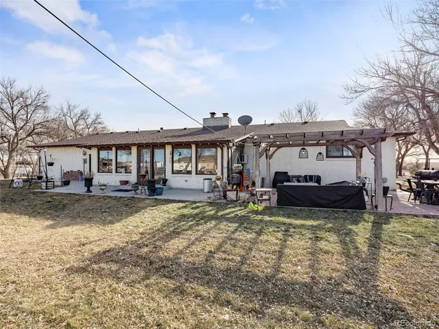 a view of a patio with couches table and chairs and potted plants