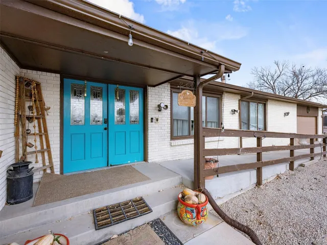 a view of a porch with furniture and floor to ceiling window