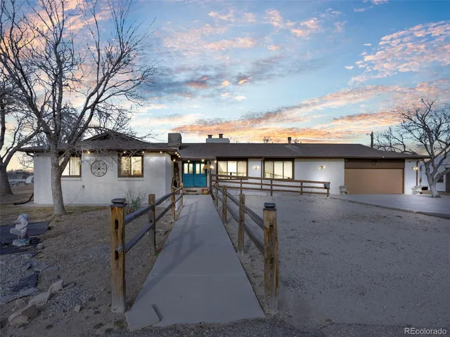 an aerial view of a house with backyard space and balcony