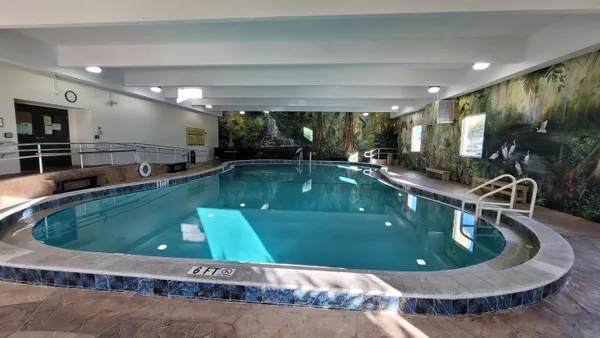 a view of a swimming pool and outdoor kitchen