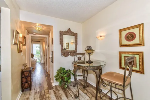 a view of hall way with furniture and livingroom