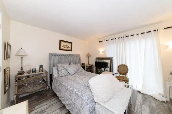 a bedroom with a bed and a chair