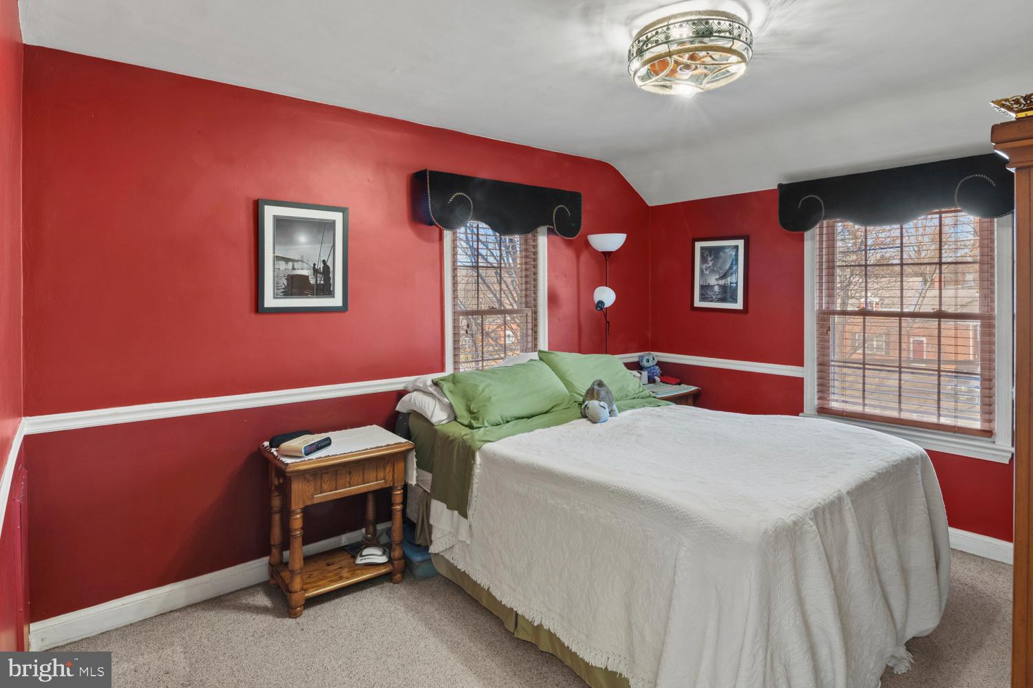 1002 Dennis Avenue Silver Spring, MD 20901 - Photo 23 of 37 a bedroom with a bed and a chandelier