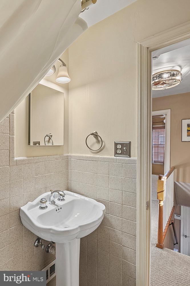1002 Dennis Avenue Silver Spring, MD 20901 - Photo 27 of 37 a bathroom with a sink a mirror and a shower