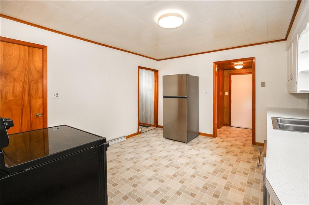 224 Boyers Road Harrisville, PA 16038 - Photo 14 of 28 a kitchen with a refrigerator and a stove