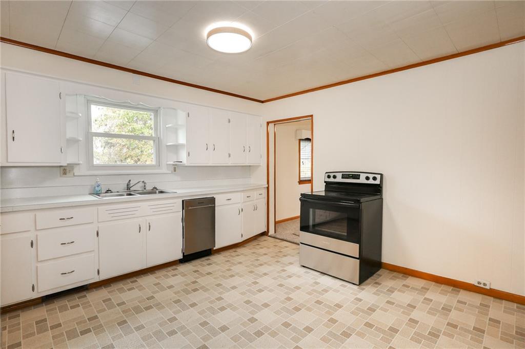 224 Boyers Road Harrisville, PA 16038 - Photo 15 of 28 a kitchen with granite countertop white cabinets and white appliances
