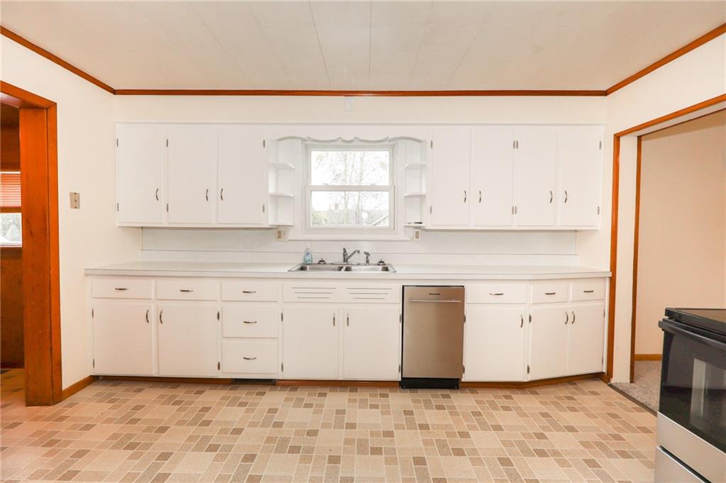 224 Boyers Road Harrisville, PA 16038 - Photo 16 of 28 a kitchen with granite countertop white cabinets white stainless steel appliances with a sink and dishwasher