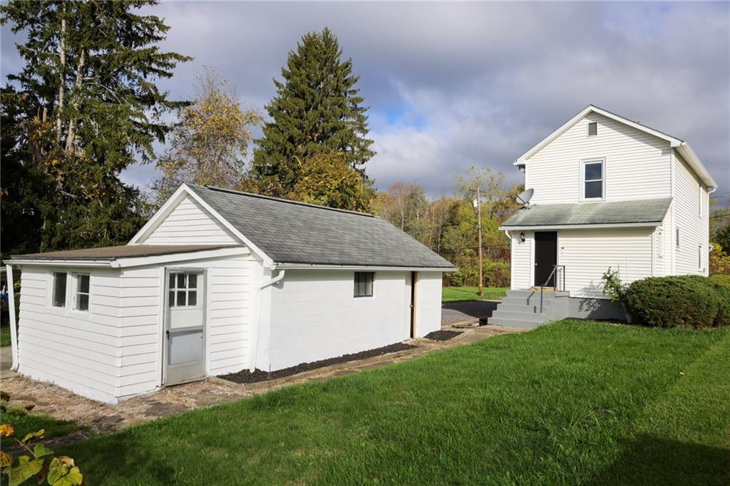 224 Boyers Road Harrisville, PA 16038 - Photo 8 of 28 a front view of a house with a garden and plants