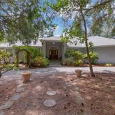 a view of a house with backyard and tree