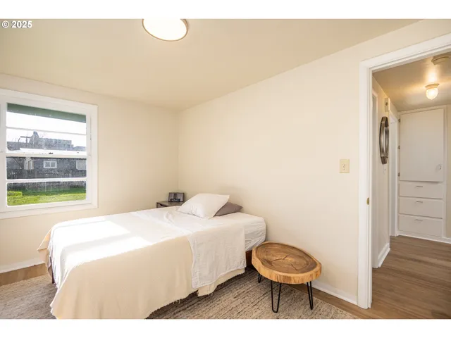 a bedroom with a bed and a mirror