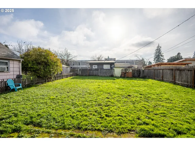 a view of a house with a yard and sitting area