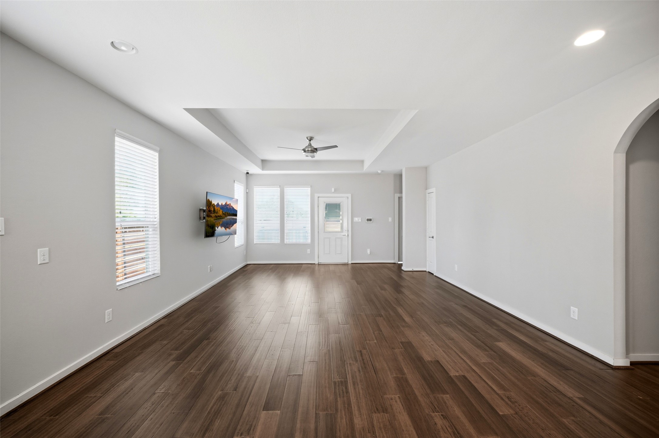 605 Dumble Street Houston, TX 77023 - Photo 16 of 44 an empty room with wooden floor and windows