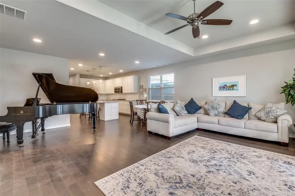 a living room with furniture and a view of kitchen