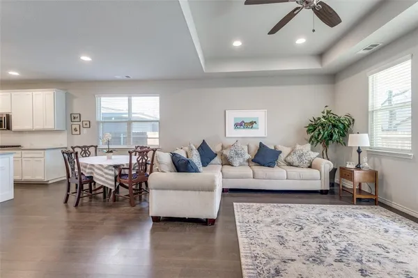 a living room with furniture and view of kitchen